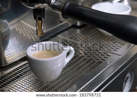 Espresso pouring into a cup in restoraunt
