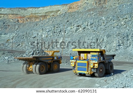 Two big trucks transport iron ore in career