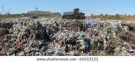 The bulldozer buries food and industrial wastes
