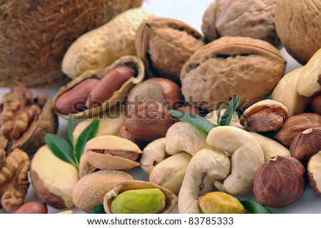 Peanuts, cashews, pistachio, almonds, walnuts, coconut, Brazil nuts and hazelnuts on a white background