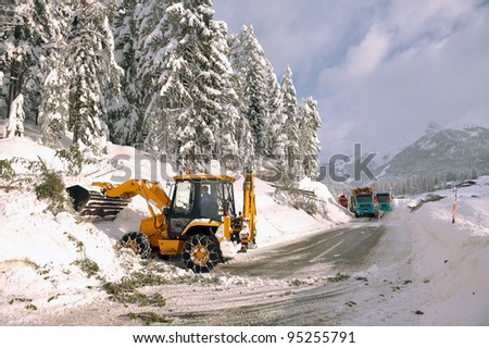 clearing roads of snow and fallen tree