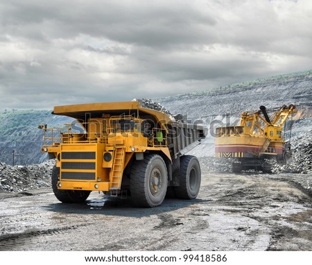 Loading of iron ore on very big dump-body truck