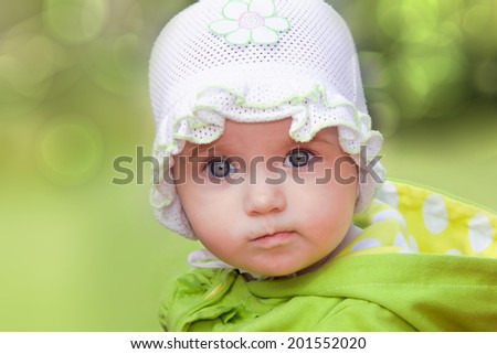 Funny baby girl looking in wide-eyed astonishment