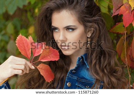 Beautiful elegant woman posing in park, autumn portrait