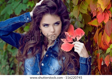 Beautiful elegant woman posing at park, autumn portrait