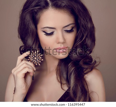 Beautiful Woman With Curly Hair And Evening Make-Up. Jewelry And Beauty. Fashion Art Photo