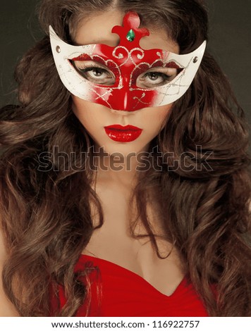Beautiful Girl in Carnival mask with long curly hair. Masquerade Holidays