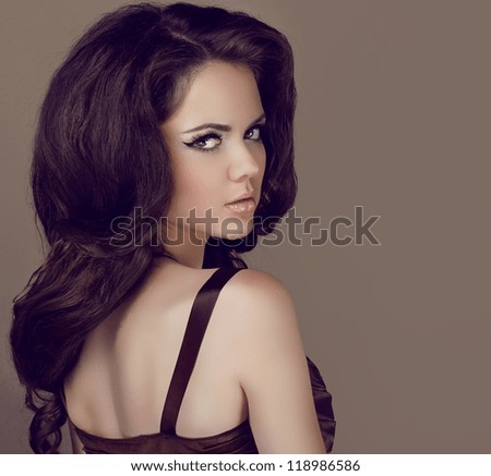 Glamour portrait of beautiful woman model with elegant makeup and romantic wavy hairstyle.
