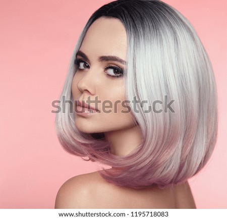 Girl Portrait of Ombre bob short hairstyle. Beautiful hair coloring woman. Trendy puprle haircut. Blond model with short shiny haircuts isolated on pink Background. Makeup. Beauty Salon.