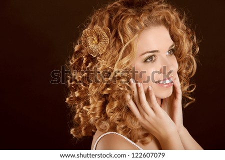 Curly Hair. Attractive smiling woman portrait on dark background. Beauty Portrait.