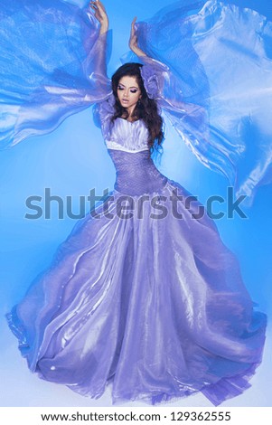 Beautiful Girl . Fashion woman in Blowing Dress Flying