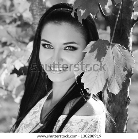 Happy smiling teen girl outdoors portrait. Black and white photo