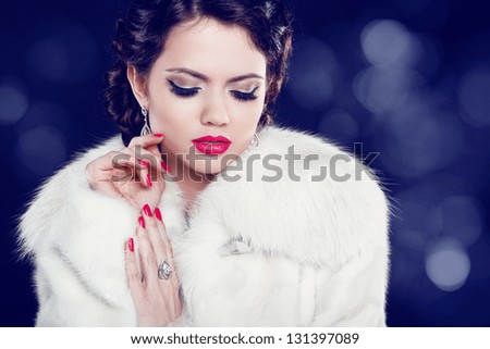 Beautiful woman with evening make-up in fur coat. Jewelry and Beauty. Fashion photo