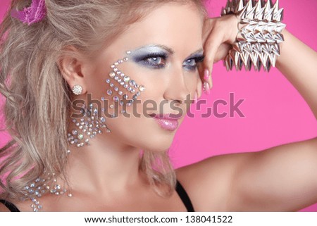 Beautiful woman with hair styling and evening make-up. Jewelry and Beauty. Fashion art photo. Punk Girl Style