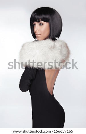 Fashion Elegant Woman in black dress. Brunette Lady with Black Short Hair. Vogue Style. Model posing at studio.