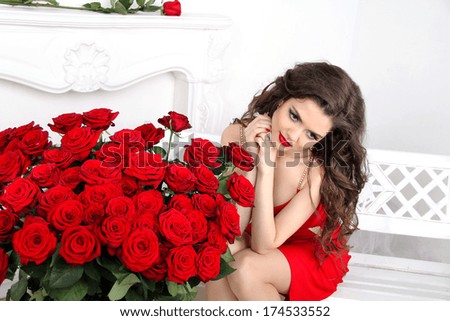 Model Woman with red roses bouquet. Valentines day. Beautiful brunette girl, luxury & good lifestyle.