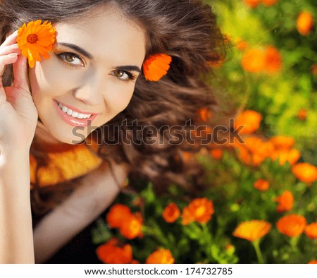 Enjoyment. Free Happy Woman Enjoying Nature. Beauty Girl Over Marigold Flowers Field. Outdoor Portrait. Freedom Concept.