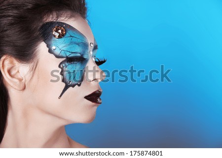 Face art portrait. Fashion Make up. Butterfly makeup on face beautiful woman.