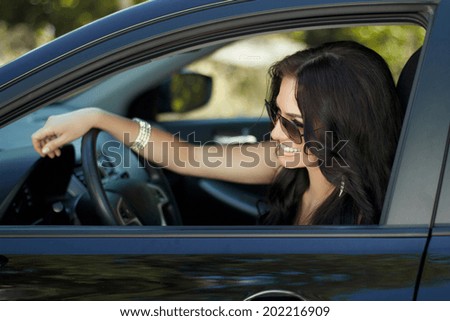 Smiling woman sitting in car, Happy girl driving automobile, outdoors summer portrait