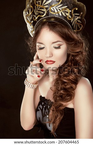 Beauty Girl with Makeup. Fashion Russian model in exclusive design clothes on manners old-Slavic. Close-up portrait.