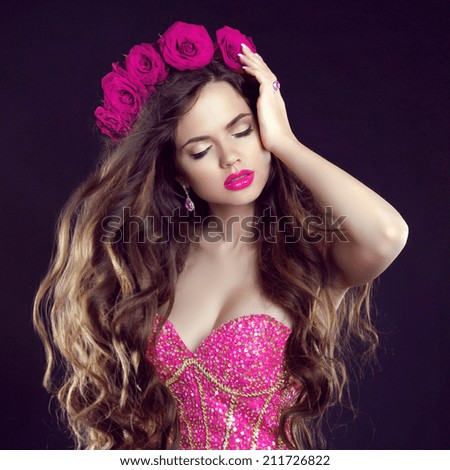 Beauty fashion girl with makeup, long wavy hair, sensual lips, glam dress, pink flowers