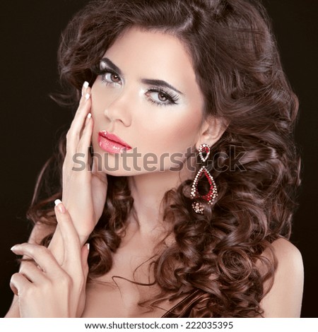 Beauty girl portrait brunette girl model with care skin, professional makeup, wavy hair styling isolated on black background