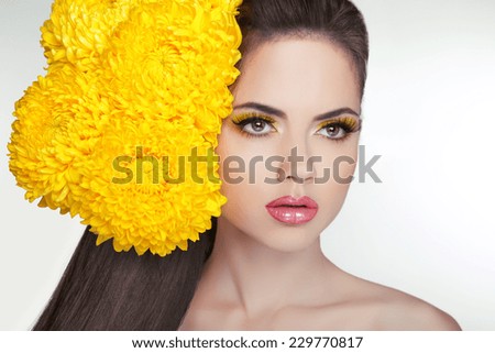 Beautiful face of young adult woman with clean fresh skin, long healthy hair. Hairstyle with flowers. Cosmetics and make-up. Girl isolated on white background.