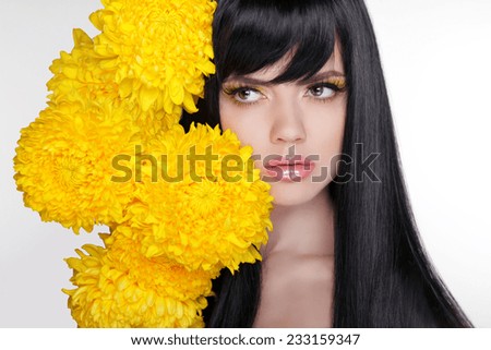 Beautiful Brunette Woman with Healthy Long Black Hair. Hairstyle with flowers.