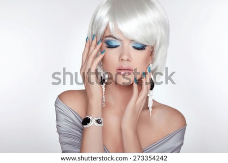 Beautiful fashion blond girl with bob hair. Makeup. Jewelry. Short straight hair Shine with health.