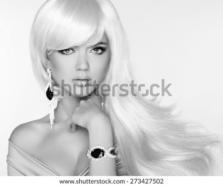 Beautiful blond woman model with long wavy hair. Luxury Jewelry. Glamour concept. Studio Fashion photo.