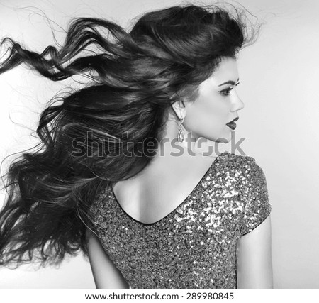 Wavy hair. Beauty fashion girl model portrait with blowing hairstyle. Sensual Lady. Black and white photo.