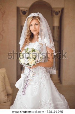 Beautiful smiling bride woman with bouquet of flowers, wedding makeup hairstyle, bridal veil. Girl wearing in white wedding dress