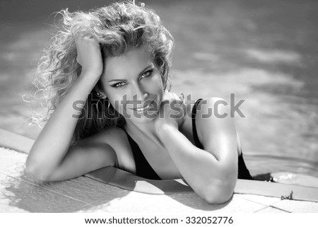 Beautiful smiling girl summer portrait. Tanned woman. Sunburn. Bronzed skin. Gray shadows colors. Black and white photo.