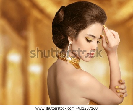 Makeup. Beautiful fashion woman in gold, elegant lady in expensive pendant  jewelry close-up. Beauty Hairstyle.