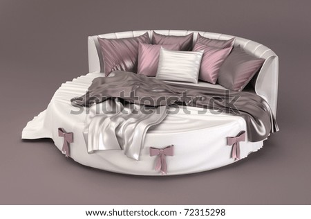 Round bed with silk pillows in bedroom interior