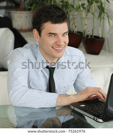 Handsome young men with laptop in public space. businessman.  smile a happy  smile