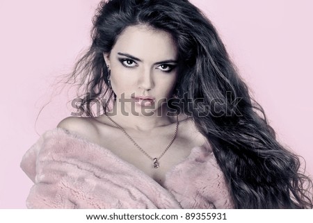 Portrait of a beautiful woman in pink fur coat