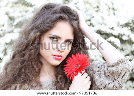 Natural beauty Young woman with red flower, outdoors portrait