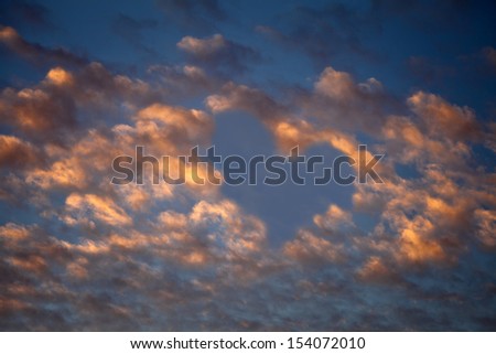 cloudy sunset sky with heart shape on it