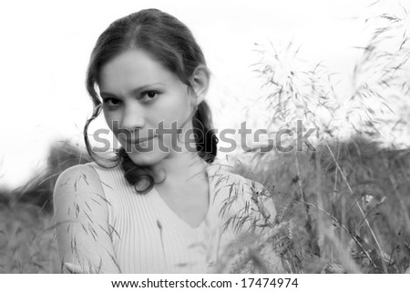 black and white photo of young woman in a field