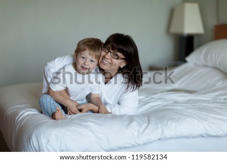 Cute toddler and pretty mom in bed
