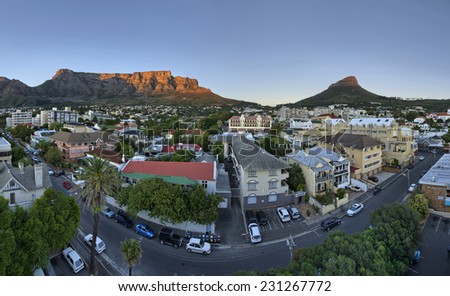 Cape Town\'s city suburb, known as \'Gardens\' in the heart of the CBD, as the sun rises early on a summers morning. Table Mountain, Signal Hill and Lions Head peaks in the background.