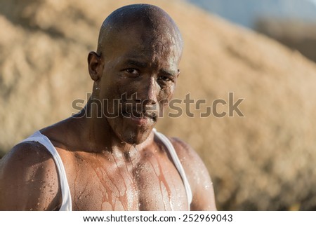 African black man, who is wet after washing his face with water. Portraying despair, worry, relief or cleanliness
