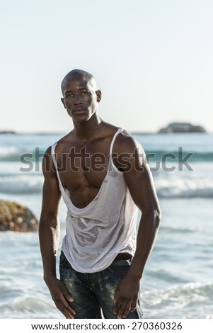 Black male model, ripping his white vest shirt