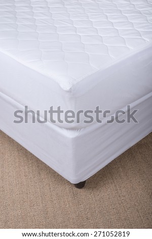 Bed corner with white sheet