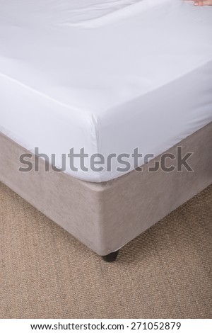 Bed corner with white sheet