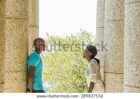 African couple hugging, having fun on date