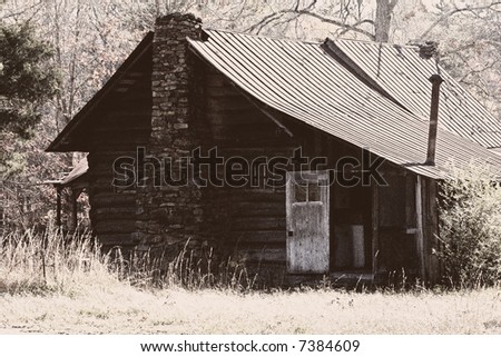 Vintage photo of old cabin with grain