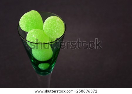 Selective focus on green gum drops in a glass./Jelly Candies