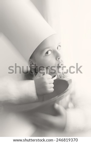 beautiful little boy cooking food black and white photography